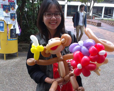 monkey holding balloon flowers